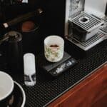 a cup of coffee sitting on top of a counter