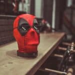 red and black mask on brown wooden table